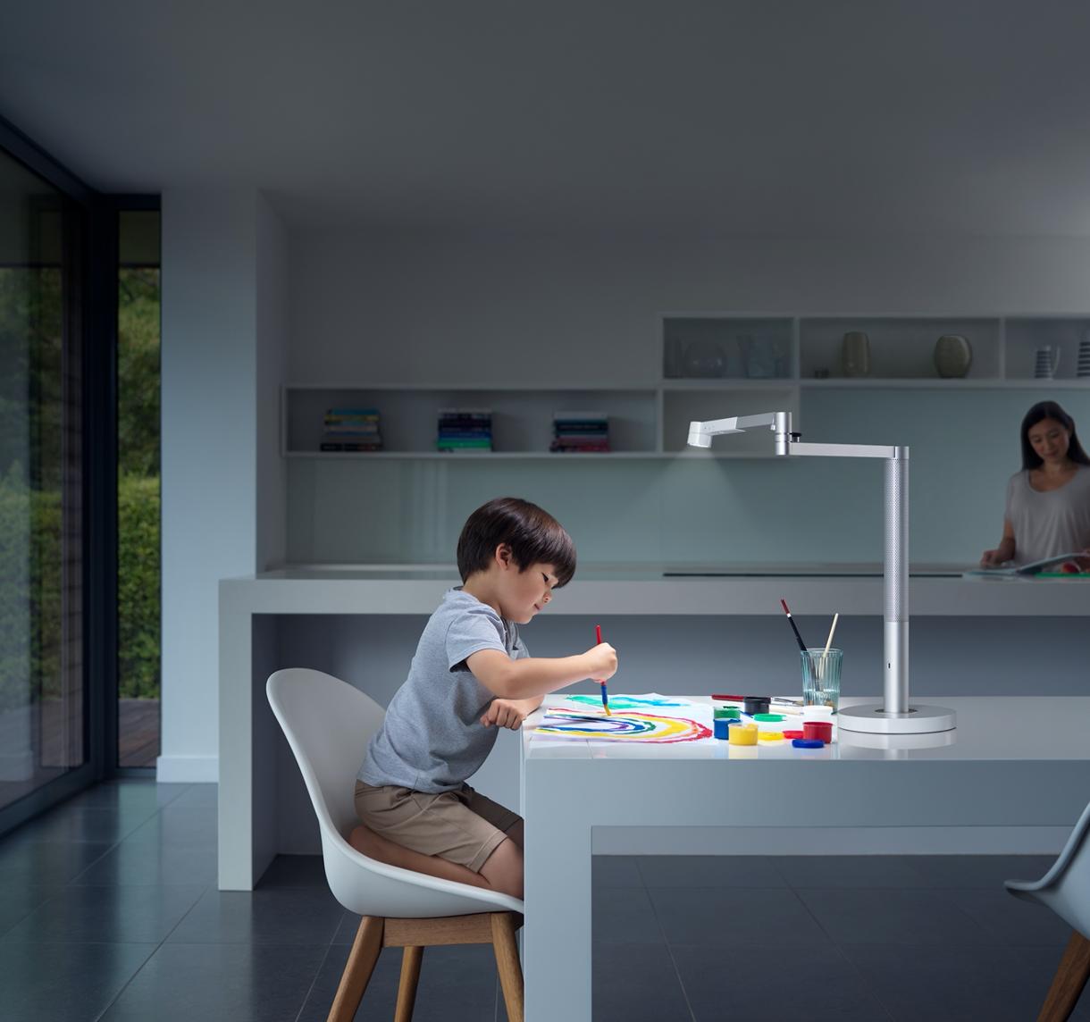 Child working efficiently using Dyson lighting.